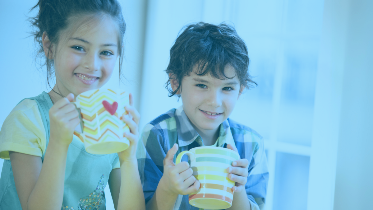 students smiling and holding mugs