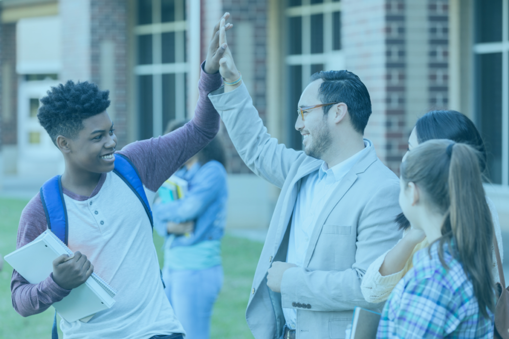 teacher high five-ing student